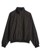 A dark brown zip-up jacket with a stand-up collar, ribbed cuffs and hem, and subtle tonal embroidered logos on the chest, displayed against a light gray background.