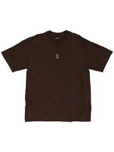 A dark brown short-sleeve t-shirt with a small beige graphic on the left chest, displayed flat against a light gray background.