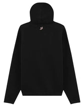 A black pullover hoodie shown from the back, featuring a small pink swirl logo centered below the neckline, set against a solid light gray background.