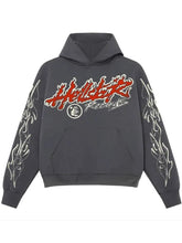 A dark gray pullover hoodie featuring a red and white 'Hollister Records' graphic on the chest, with white flame-style sleeve prints, shown against a plain white background.