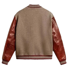 A classic varsity-style jacket shown from the back, featuring a heathered taupe-brown wool body and glossy reddish-brown leather sleeves, finished with striped ribbed collar, cuffs, and hem.