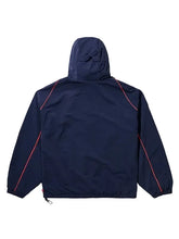 A navy blue hooded jacket shown from the back, featuring bright red contrast piping along the shoulders and sleeves, set against a solid light gray background.