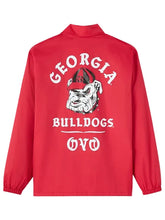 A red long-sleeve jacket with a high collar, featuring a large white and black graphic on the back with the text 'GEORGIA BULLDOGS' and the Bulldogs mascot illustration.
